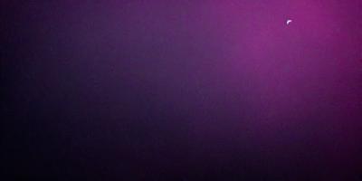 The image is a purple background with a black and white photo of a wall. The wall appears to be a dark purple color, and the photo has a slightly blurred appearance. The overall atmosphere of the image is moody and dramatic.