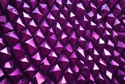 The primary subject of the image is a large, purple wall with a pattern of purple and pink triangles. The setting is a room with a purple background, and the visual style appears to be a combination of digital art and illustration. The dominant colors and overall atmosphere of the image are purple and pink, creating a vibrant and visually appealing scene.