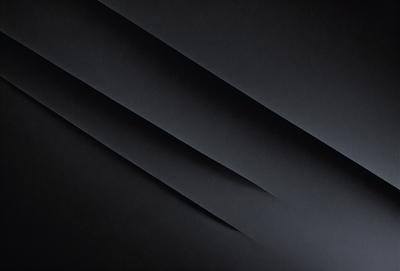 The primary subject of the image is a black and white photo of a curved, wavy line. The setting is a black background, which emphasizes the line's shape and texture. The visual style is a close-up of the line, showcasing its intricate details. The colors and mood of the image are predominantly dark and moody, with the black background and the line's shape creating a dramatic and artistic effect.