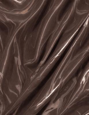 The primary subject of the image is a brown, wrinkled piece of fabric. The setting is a close-up of the fabric, showcasing its texture and pattern. The visual style is a detailed, up-close view of the fabric. The colors and mood of the image are dominated by the brown hues of the fabric, giving it a natural and earthy appearance.