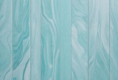 The primary subject of the image is a blue and white striped wall. The setting is a room with a blue and white striped wall, which serves as the background. The visual style of the image is a photo, capturing the details of the striped wall. The dominant colors in the image are blue and white, creating a calm and soothing atmosphere.