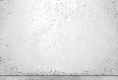 The primary subject of the image is a white wall with a few black spots. The setting is a room with a concrete wall, and the visual style is a photo. The colors and mood of the image are predominantly white and grey, giving it a clean and minimalist appearance.