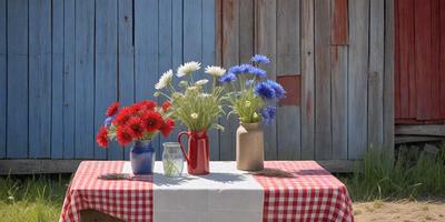 The primary subject of the image is a table with a tablecloth and three vases filled with flowers. The flowers are arranged in the vases, creating a visually appealing display. The setting is outdoors, with a blue wall in the background. The visual style is a photo, capturing the beauty of the flowers and the table arrangement. The colors and mood of the image are predominantly warm and inviting, with the flowers adding a touch of natural beauty to the scene.