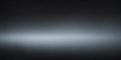 The primary subject of the image is a black background with a white line. The setting is a dark room, and the visual style is a black and white photo. The colors and mood of the image are predominantly dark and moody, with the white line providing a contrasting element.