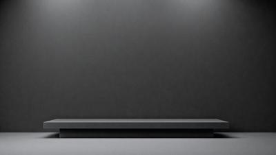 The primary subject of the image is a laptop computer. The laptop is sitting on a table, and it is turned on. The setting is a room with a gray wall, and the visual style is a photo. The laptop is the main focus of the image, and it appears to be the primary subject. The colors and mood of the image are neutral, with the gray wall and laptop creating a calm and professional atmosphere.