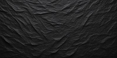 The primary subject of the image is a black and white photograph of a wrinkled, textured surface. The setting is a black background, which contrasts with the wrinkled surface. The visual style is a close-up of the wrinkled surface, showcasing its intricate texture. The colors and mood of the image are predominantly black and white, giving it a classic and timeless feel.