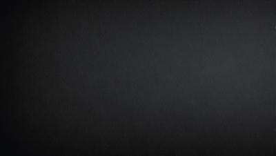 The primary subject of the image is a black background. The setting is a dark, empty space, with no visible objects or elements. The visual style is a black and white photo, which gives the image a classic and timeless appearance. The colors and mood are predominantly dark and moody, creating a sense of mystery and depth.