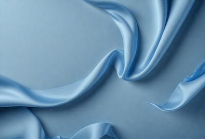 The primary subject of the image is a blue fabric, possibly a piece of silk, with a flowing and curling pattern. The setting is a blue background, which complements the blue fabric. The visual style is a digital art or illustration, as the fabric appears to be digitally rendered. The colors and mood of the image are predominantly blue, creating a calm and serene atmosphere.