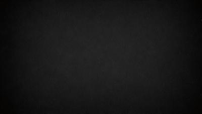 The primary subject of the image is a black background. The setting is a dark, empty space with no visible objects or elements. The visual style is a simple, monochromatic design. The colors and mood are predominantly dark and moody, creating a sense of mystery or drama.
