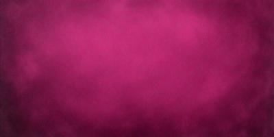 The primary subject of the image is a large, pink surface. The setting is a dark, cloudy sky, creating a moody atmosphere. The visual style is a close-up of the pink surface, which appears to be a piece of fabric. The colors and mood of the image are predominantly pink, with a hint of darkness from the cloudy sky.