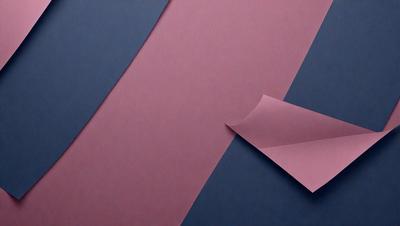 The primary subject of the image is a piece of pink paper. The setting is a blue background, and the visual style appears to be a photo. The colors and mood of the image are predominantly pink and blue, creating a calm and serene atmosphere.