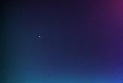 The primary subject of the image is the night sky, which is filled with stars. The setting is a dark, clear night with a few stars visible in the sky. The visual style is a photo of the night sky, capturing the beauty of the celestial bodies. The colors and mood of the image are predominantly dark and serene, with the stars providing a sense of wonder and tranquility.