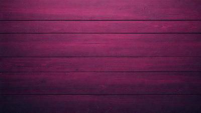 The primary subject of the image is a wooden wall with a purple color. The setting is a room with a wooden surface, and the visual style appears to be a photo. The dominant colors are purple and brown, creating a warm and cozy atmosphere.