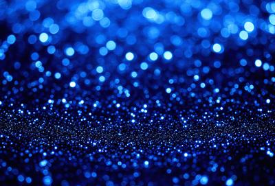 The primary subject of the image is a blue background with a pattern of blue lights. The setting appears to be a dark room, and the visual style is a close-up of the blue lights. The colors and mood of the image are predominantly blue, creating a calm and serene atmosphere.