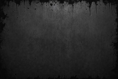 The primary subject of the image is a black and white photo of a wall. The setting is a dark room, and the visual style is a close-up of the wall. The colors and mood of the image are predominantly dark and moody, with the black and white color scheme adding to the atmosphere.