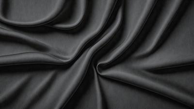 The primary subject of the image is a close-up of a piece of fabric, likely a piece of clothing or a curtain. The setting is a dark background, which emphasizes the fabric's texture and pattern. The visual style appears to be a photo, as it captures the details of the fabric. The colors and mood of the image are predominantly dark, with the fabric being the main focus.