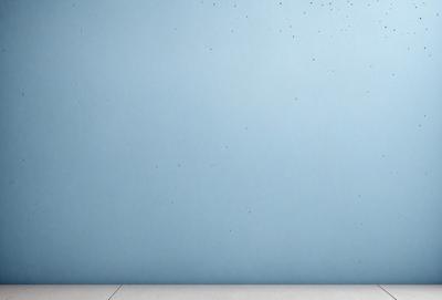 The primary subject of the image is a blue wall with a white frame. The setting is a room with a blue wall, and the visual style is a photo. The dominant colors are blue and white, creating a calm and serene atmosphere.