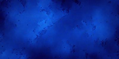 The primary subject of the image is the night sky, which is filled with stars. The setting is a dark blue background, creating a contrasting and dramatic effect. The visual style is a combination of a photo and digital art, as the image captures the beauty of the night sky while also showcasing the intricate details of the stars. The colors and mood of the image are predominantly dark and moody, with the blue hue of the sky and the twinkling lights of the stars creating a serene and