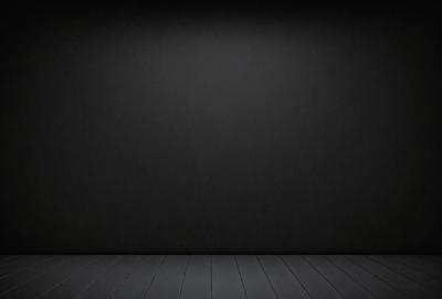 The primary subject of the image is a black wall with a black background. The setting is a room with a wooden floor. The visual style is a black and white photo. The dominant colors and overall atmosphere are dark and moody.