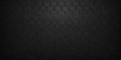 The primary subject of the image is a black and white patterned fabric. The setting is a black background, and the visual style is a close-up of the pattern. The colors and mood of the image are predominantly black and white, giving it a classic and elegant appearance.