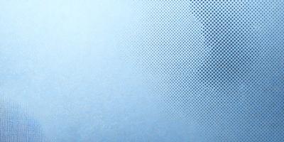 The primary subject of the image is a blue background with a pattern of white dots. The setting appears to be a room with a blue wall, and the visual style is a combination of a photo and a pattern. The dominant colors are blue and white, creating a calm and soothing atmosphere.