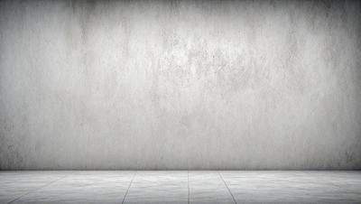 The primary subject of the image is a large, white, concrete wall. The setting is a plain, empty room with the wall as the main focus. The visual style is a photo, capturing the concrete wall in its natural environment. The colors and mood of the image are predominantly neutral, with the white wall being the main color, and the overall atmosphere being calm and uncluttered.