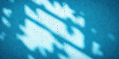 The primary subject of the image is a set of bars or a metal fence. The setting is a concrete surface, and the visual style appears to be a photo. The dominant colors in the image are blue and white, creating a calm and serene atmosphere.