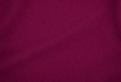 The primary subject of the image is a close-up of a maroon fabric. The setting is a dark background, which contrasts with the maroon fabric. The visual style is a close-up of the fabric, showcasing its texture and color. The colors and mood of the image are predominantly dark and moody, with the maroon fabric being the main focus.
