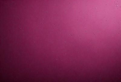 The primary subject of the image is a pink wall with a pattern of white dots on it. The setting is a room with a pink background, and the visual style appears to be a photo. The dominant colors are pink and white, creating a warm and inviting atmosphere.