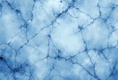 The primary subject of the image is a blue, textured surface with a cracked and bumpy appearance. The setting is a blue background, and the visual style is a digital art or illustration. The dominant colors are blue and white, creating a calm and serene atmosphere.