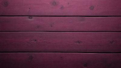 The primary subject of the image is a wooden wall with a purple color. The setting is a wooden wall, and the visual style is a photo. The dominant colors are purple and brown, creating a warm and cozy atmosphere.