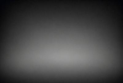 The image is a black and white photo of a gray sky. The sky is the primary subject, and it appears to be a cloudy day. The setting is an open area with no visible landmarks or objects. The visual style is a traditional black and white photo, which gives the image a timeless and classic feel. The colors and mood are predominantly gray and subdued, creating a calm and serene atmosphere.
