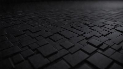 The primary subject of the image is a black and white patterned surface, which appears to be a tile or a black and white checkered floor. The setting is a dark room, and the visual style is a close-up of the patterned surface. The colors and mood of the image are predominantly black and white, creating a sense of depth and contrast.