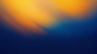 The primary subject of the image is a sunset, with the sun's rays creating a beautiful and colorful display. The setting is a cloudy sky, which adds to the overall atmosphere of the scene. The visual style of the image is a photo, capturing the natural beauty of the sunset. The dominant colors in the image are orange, yellow, and blue, creating a warm and inviting mood.
