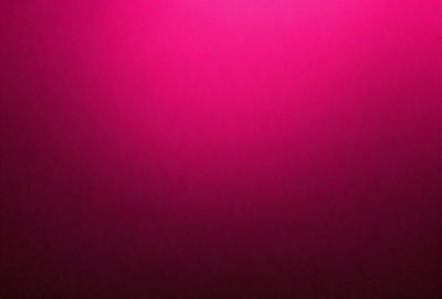 The primary subject of the image is a pink wall. The setting is a room with a pink background. The visual style is a close-up of the pink wall, which gives a sense of depth and texture. The dominant colors are pink, and the overall atmosphere is warm and inviting.