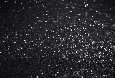The primary subject of the image is a black background with a pattern of white stars. The setting is a dark, starry night, and the visual style is a combination of a photo and digital art. The dominant colors are black and white, creating a moody and dramatic atmosphere.