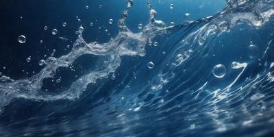 The primary subject of the image is a wave in the ocean. The wave is breaking and creating a splash, with water droplets visible in the air. The setting is the ocean, and the visual style is a photo. The dominant colors are blue and white, and the overall atmosphere is dynamic and energetic.