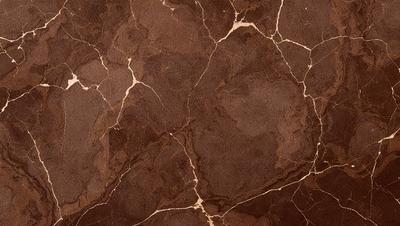 The primary subject of the image is a close-up of a marble surface with a brown and yellow color palette. The setting is a marble wall, and the visual style is a photo. The colors and mood of the image are warm and natural, with the marble surface giving a sense of luxury and elegance.