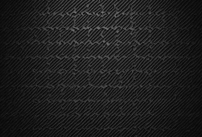 The primary subject of the image is a black and white patterned surface. The setting is a black background, and the visual style appears to be a pattern or texture. The dominant colors are black and white, creating a mood of simplicity and elegance.