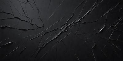The primary subject of the image is a black background with a cracked or broken surface. The setting appears to be a dark room, and the visual style is a close-up of the cracked surface. The colors and mood of the image are predominantly dark and moody, with the cracked surface creating a sense of unease or tension.