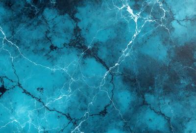 The primary subject of the image is a blue and white marbled wall. The setting is a room with a blue and white marbled wall as the main focus. The visual style is a photo of the marbled wall. The dominant colors are blue and white, creating a calm and soothing atmosphere.