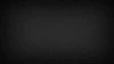 The image is a black and white photo of a dark background.