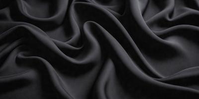 The primary subject of the image is a close-up of a black fabric, possibly a piece of clothing or a curtain. The setting is a dark room, and the visual style appears to be a photo. The dominant colors are black, and the overall atmosphere is mysterious and dramatic.