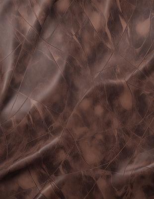 The primary subject of the image is a piece of leather, which is the main object, scene, or focus of the image. The setting/background features a brown leather surface, which is the environment, backdrop, or surface visible in the image. The visual style of the image is a photo, as it is a real-life representation of the leather material. The colors and mood of the image are dominated by the brown leather, giving it a natural and earthy appearance.
