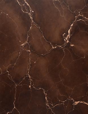 The image features a close-up of a marble surface with a brown and gold color palette. The marble has a distinctive pattern, giving it a unique and luxurious appearance. The setting appears to be a room with a brown and gold color scheme, which complements the marble surface. The visual style of the image is a close-up, allowing the viewer to appreciate the intricate details of the marble pattern. The colors and mood of the image convey a sense of sophistication and elegance