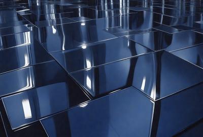 The primary subject of the image is a reflection of a building in a mirrored surface. The setting is a room with a mirrored wall, and the visual style is a photo. The dominant colors in the image are blue and silver, creating a calm and serene atmosphere.