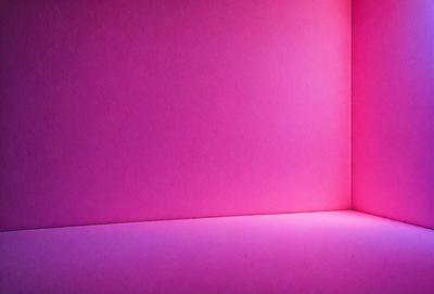 The primary subject of the image is a pink wall. The setting is a room with a pink wall, and the visual style is a photo. The dominant colors in the image are pink, and the overall atmosphere is bright and warm.
