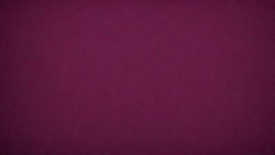 The primary subject of the image is a purple background. The setting is a dark room, and the visual style is a close-up of the purple background. The colors and mood of the image are predominantly purple, creating a calm and serene atmosphere.