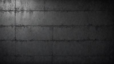 The primary subject of the image is a gray wall with a rough texture. The setting is a dark room, and the visual style appears to be a photo. The dominant colors are gray and black, creating a moody atmosphere.