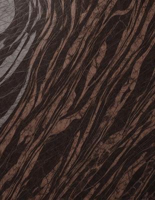 The primary subject of the image is a close-up of a wooden surface with a marbled pattern. The setting is a room with a wooden floor, and the visual style is a photo. The colors and mood of the image are predominantly brown and earthy, giving it a natural and warm atmosphere.